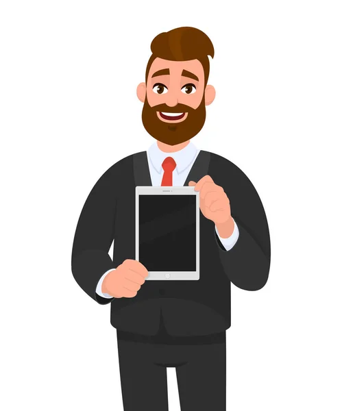 Positive happy young bearded business man showing / holding blank screen of digital tablet computer in hands. Современные технологии, новейшие тенденции, цифровой гаджет и концепция устройства иллюстрации в мультфильме . — стоковый вектор