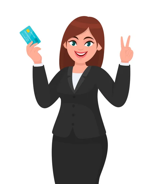 Professionell affärskvinna visar/innehar kredit/bankkort/ATM bank kort och gesturing/göra seger, v, fred eller två tecken med handen fingrar. Modern livsstil, senaste trenden, digital teknik. — Stock vektor