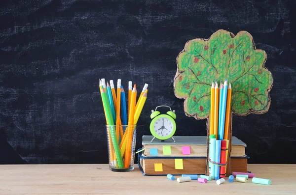 Back to school concept. tree of knowledge and pencils in front of classroom blackboard