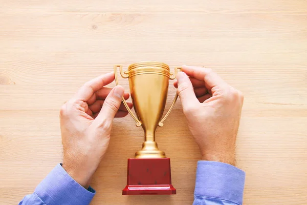 Image Businessman Holding Golden Trophy Wooden Table — Stock Photo, Image