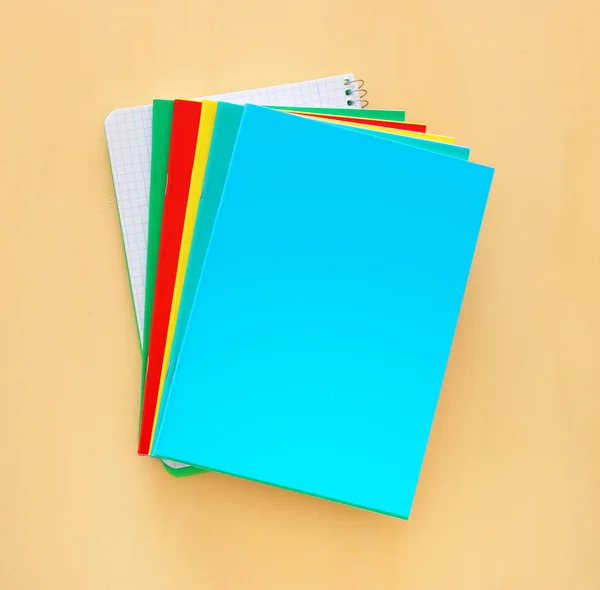 Top view of notebooks over wooden background. — Stock Photo, Image