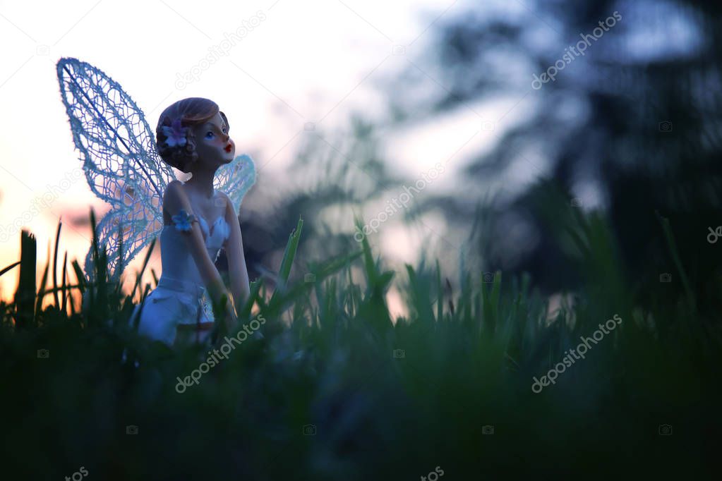 image of magical little fairy in the forest at sunset