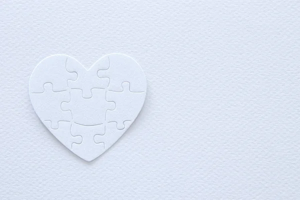 Top view image of paper white heart puzzle. Health care, donate, world heart day and world health day concept