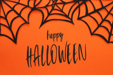 Cadılar Bayramı tatil kavramı. Turuncu arka plan üzerinde örümcek ağları. Üstten görünüm, düz yatıyordu