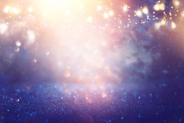 Glitter vintage ışıklar arka plan. siyah, mavi, mor ve altın. de-odaklı