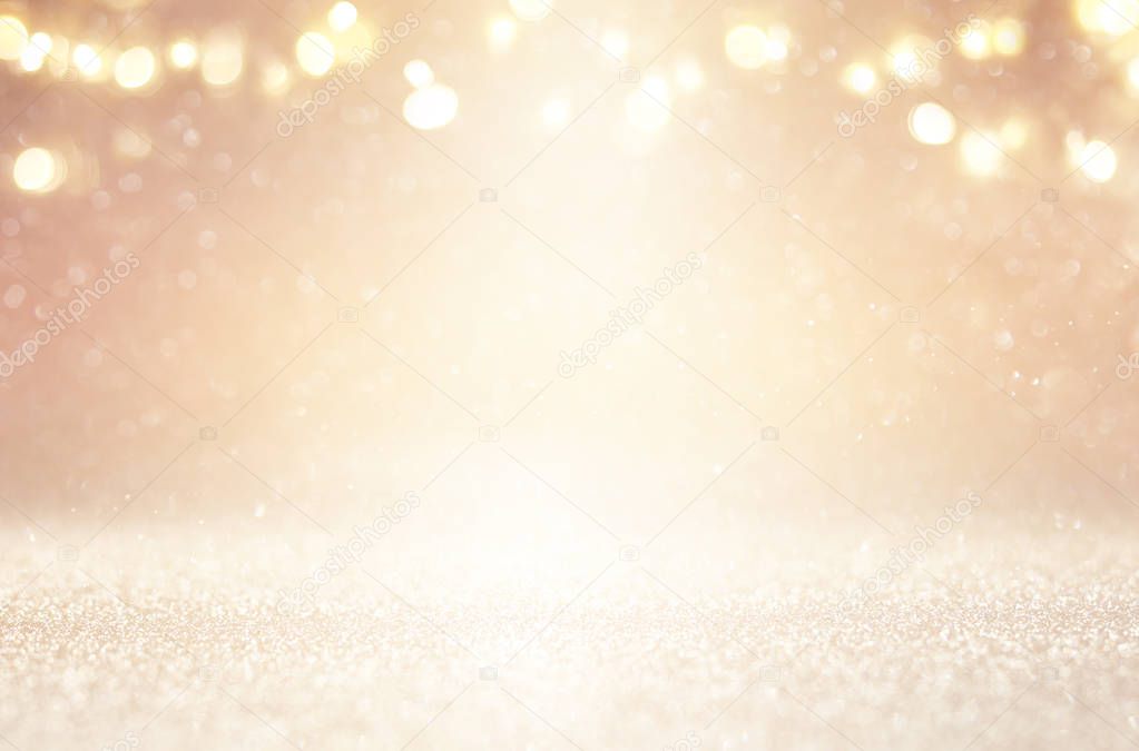 glitter vintage lights background. silver, gold and white. de-focused