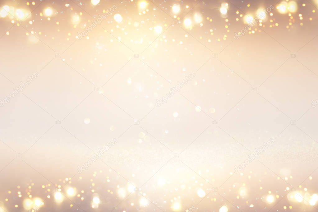 glitter vintage lights background. silver, gold and white. de-focused