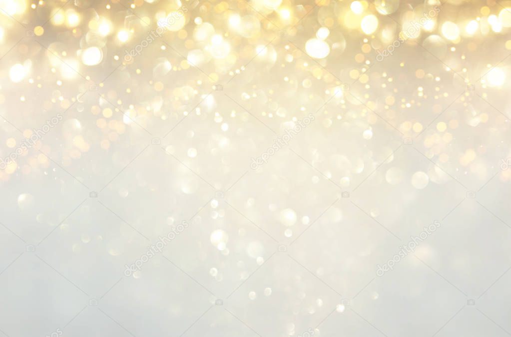 glitter vintage lights background. silver, gold and white. de-focused