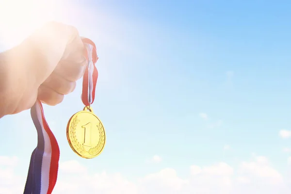 Man Hand Raised Holding Gold Medal Sky Award Victory Concept — Stock Photo, Image