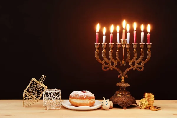 image of jewish holiday Hanukkah background with menorah (traditional candelabra) and burning candles