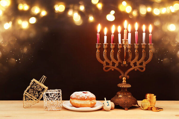 image of jewish holiday Hanukkah background with menorah (traditional candelabra) and burning candles