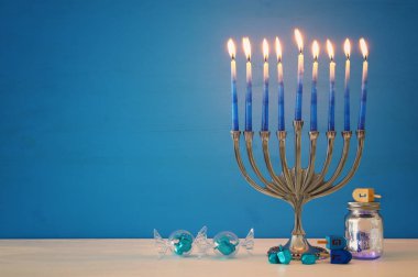 image of jewish holiday Hanukkah background with menorah (traditional candelabra) and candles clipart
