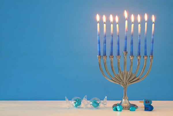 image of jewish holiday Hanukkah background with menorah (traditional candelabra) and candles