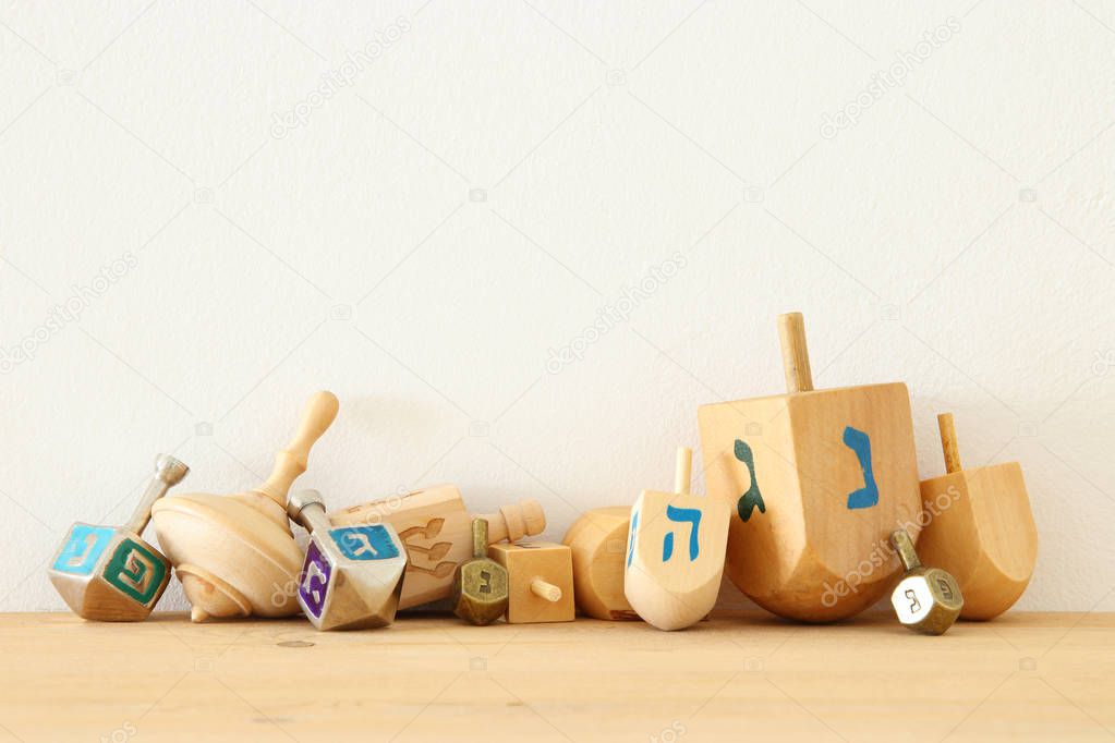 Banner of jewish holiday Hanukkah with wooden dreidels (spinning top)