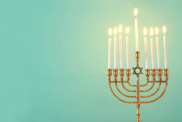 image of jewish holiday Hanukkah background with menorah (traditional candelabra) and candles