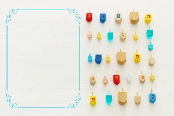 Image of jewish holiday Hanukkah with wooden dreidels colection (spinning top) over white background