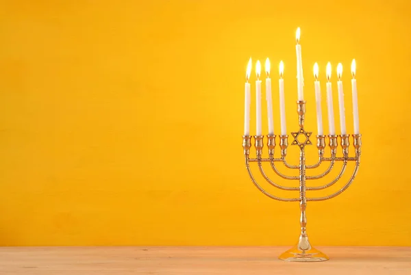 image of jewish holiday Hanukkah background with menorah (traditional candelabra) and candles