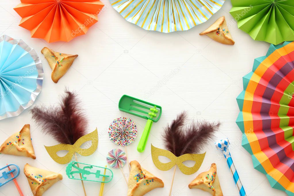 Purim celebration concept (jewish carnival holiday) over white wooden background. Top view - Image