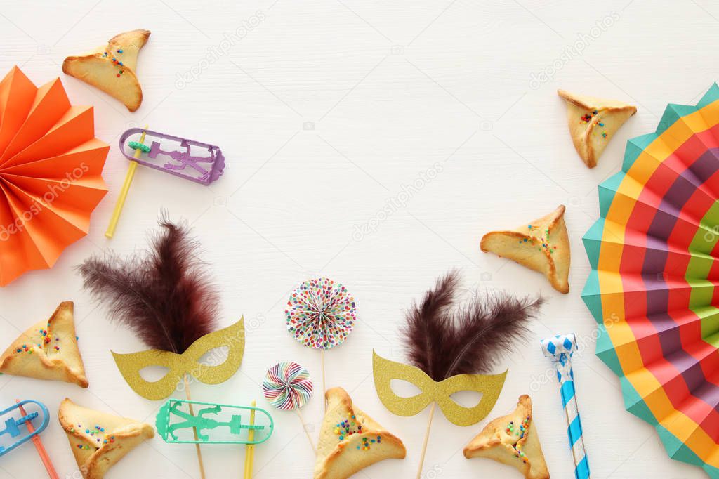 Purim celebration concept (jewish carnival holiday) over white wooden background. Top view - Image