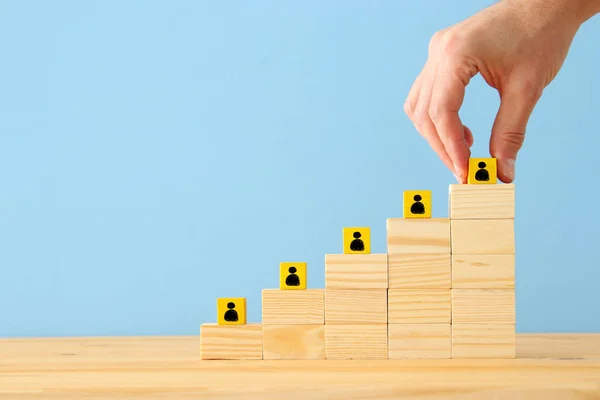 photo of blocks with people icons over wooden table ,human resources and management concept