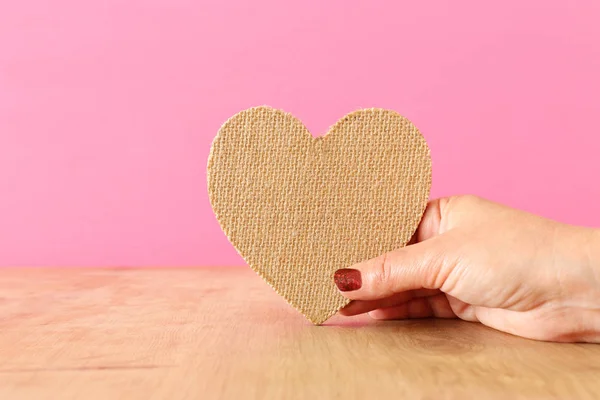 Female Heand Holding Heart Wooden Table — Stock Photo, Image