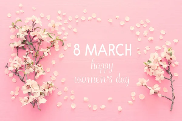 International women day concept. Cherry tree and date text. Top view image