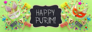 Purim kutlama kavram (Yahudi karnaval tatil) ahşap yeşil arka plan üzerinde. Üstten Görünüm, düz yatıyordu. afiş