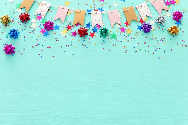 Party colorful confetti over light pastel blue wooden background . Top view, flat lay — Stock Photo, Image