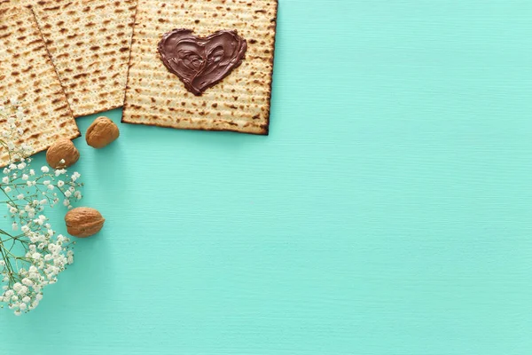 Pesah viering concept (Joodse Pascha vakantie) met chocolade hart over matzah. Bovenaanzicht plat leggen — Stockfoto