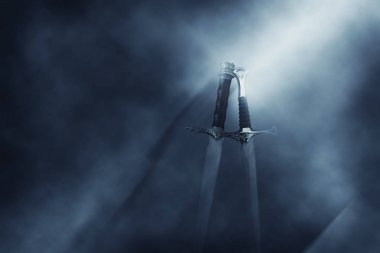 mysterious and magical photo of silver sword over gothic black background with smoke. Medieval period concept clipart