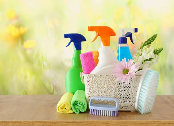 Spring cleaning concept with supplies on wooden table — Stock Photo, Image