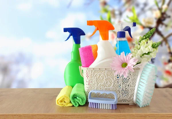 Spring cleaning concept with supplies on wooden table — Stock Photo, Image