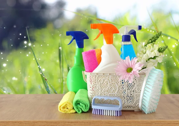 Spring cleaning concept with supplies on wooden table — Stock Photo, Image