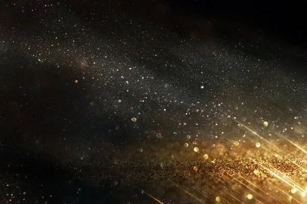 Glitter vintage ışıklar arka plan. siyah ve altın. de-odaklı