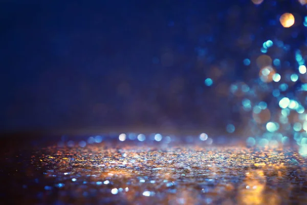 Glitter vintage lights background. black, purple, blue and gold. de-focused — Stock Photo, Image