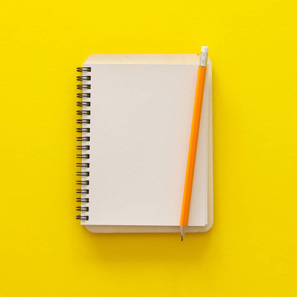 blank notebook over yellow background. ready for mockup. Top view flat lay