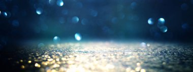 glitter vintage ışıklar arka plan. siyah, mavi ve altın. de-focu