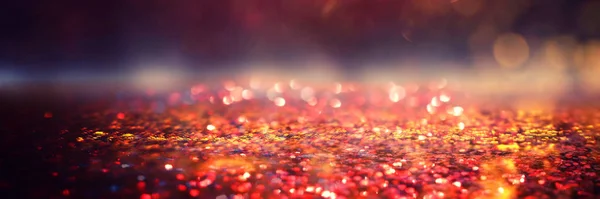 Glitter vintage lights background. black, gold and red. de-focus — Stock Photo, Image