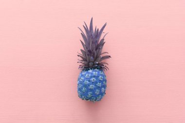 pembe ahşap arka plan üzerinde mor ananas soyut fotoğraf. Plaj ve tropikal tema. Üstte görüntü