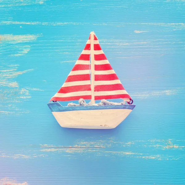 Wooden vintage boat over blue background — Stock Photo, Image