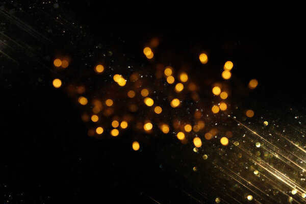 блестки винтажные огни фона. черный и золотой. de-focused
