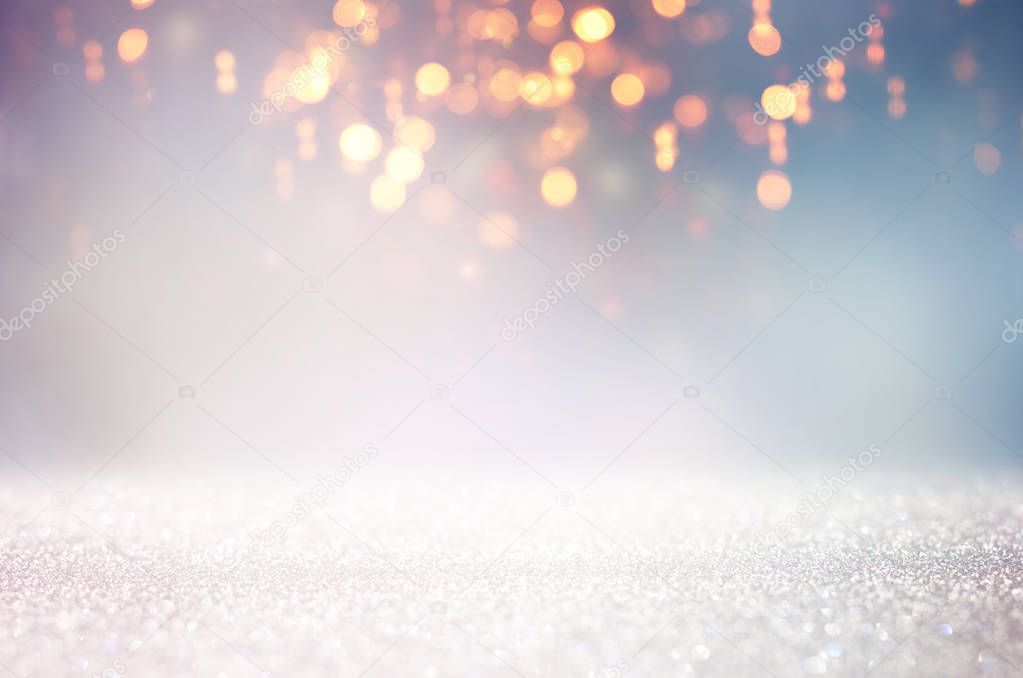 abstract glitter silver and gold lights background. de-focused