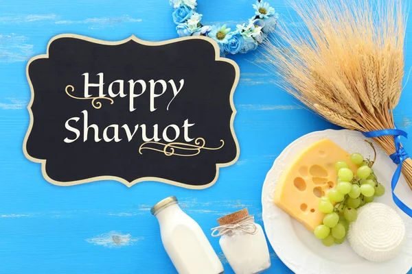 Foto von oben mit Milchprodukten vor blauem Holzhintergrund. Symbole des jüdischen Feiertags - Shavuot — Stockfoto