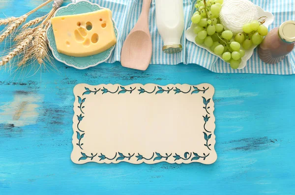 Top view photo of dairy products over blue wooden background. Symbols of jewish holiday - Shavuot — Stock Photo, Image