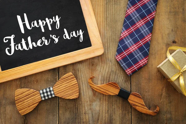 Father's day concept. gift box, tie and funny moustache over wooden background. top view, flat lay — Stock Photo, Image