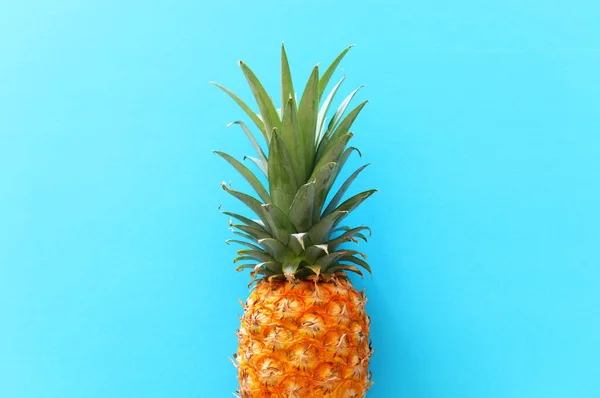 Ripe pineapple over blue background. Beach and tropical theme. Top view