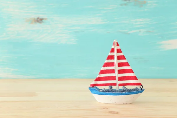 Ahşap masa veya raf ve pastel mavi arka plan üzerinde vintage tekne — Stok fotoğraf