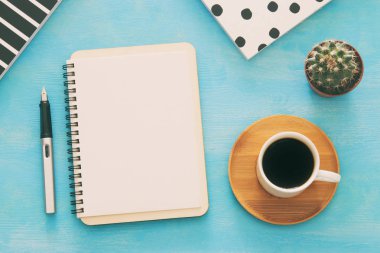 Mavi ofis masası üzerinde boş sayfalar ve diğer ofis malzemeleri ile defter açın. Üstte görüntü
