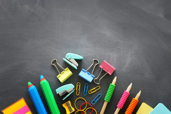 Back to school concept. stationery and books over classroom blackboard. top view, flat lay — Stock Photo, Image