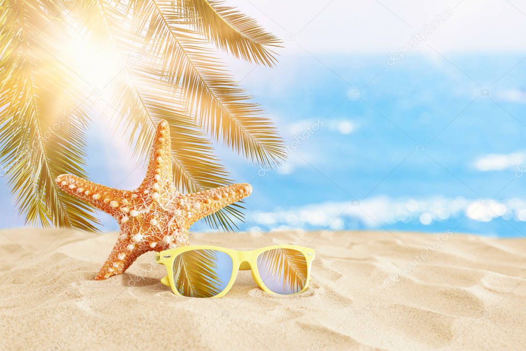 holidays. sand beach, sunglasses and starfish in front of summer